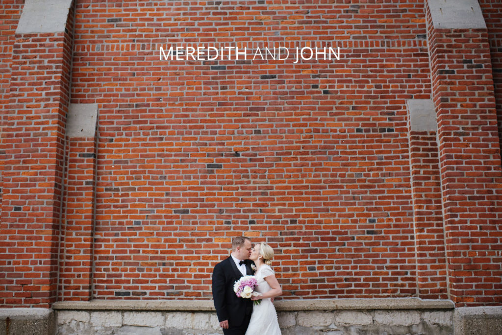 Meredith-and-John | Jessica Miller Photography bride and groom kissing in front of brick wall