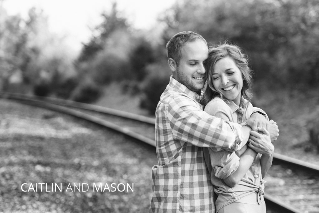 Caitlin and Mason | Jessica Miller Photography engaged couple hugging by railroad tracks