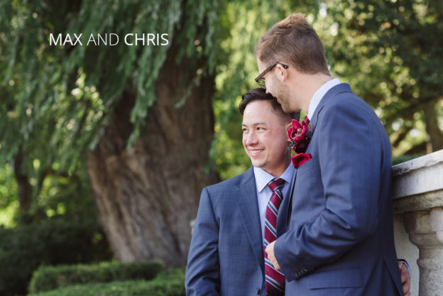 man kissing husband in a park