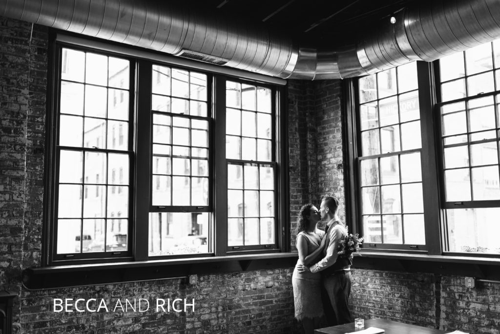 Becca and Rich | Jessica Miller Photography married couple kisses in front of brick wall