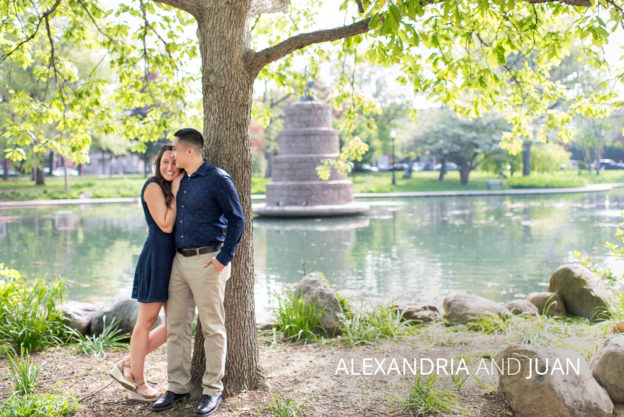happy engaged couple under a tree