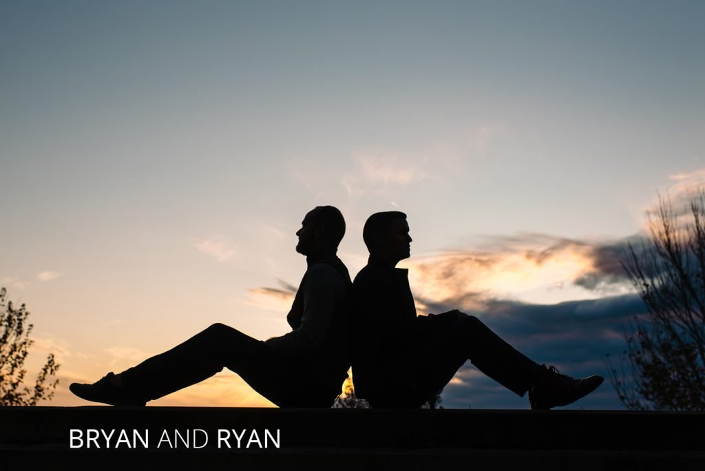 Bryan and Ryan sitting back to back on a Columbus Bridge