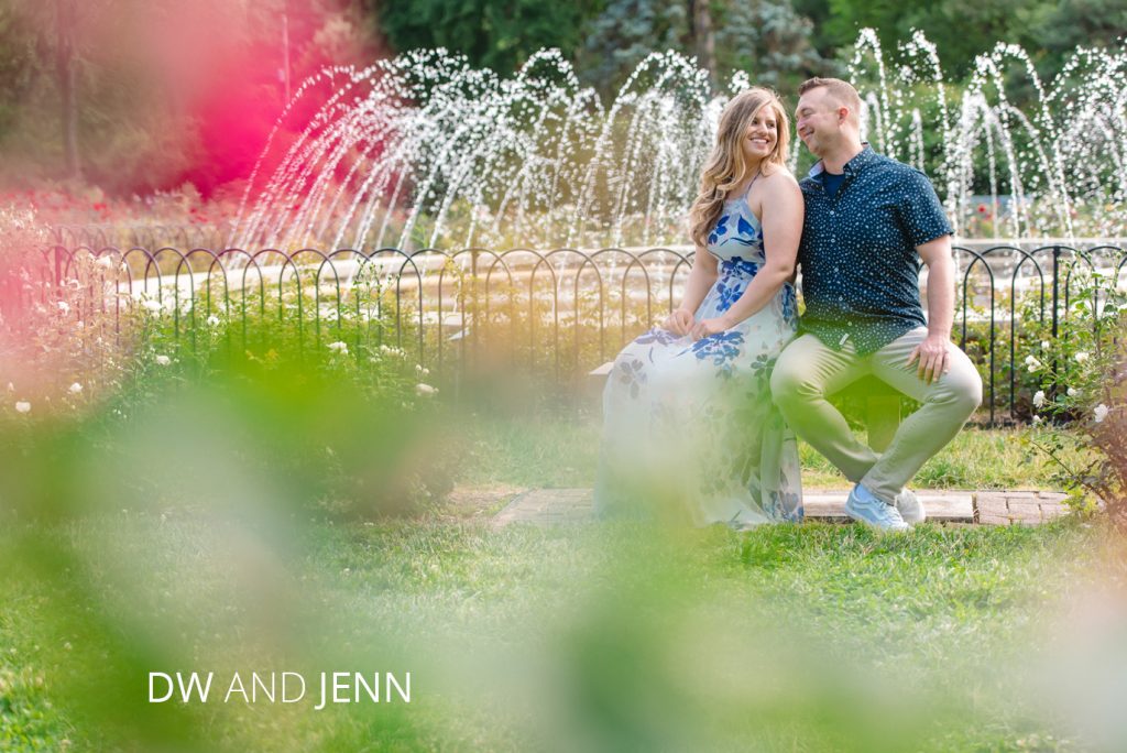 whetstone park of roses engagement | Jessica Miller Photography jenn and DW sitting by a fountain