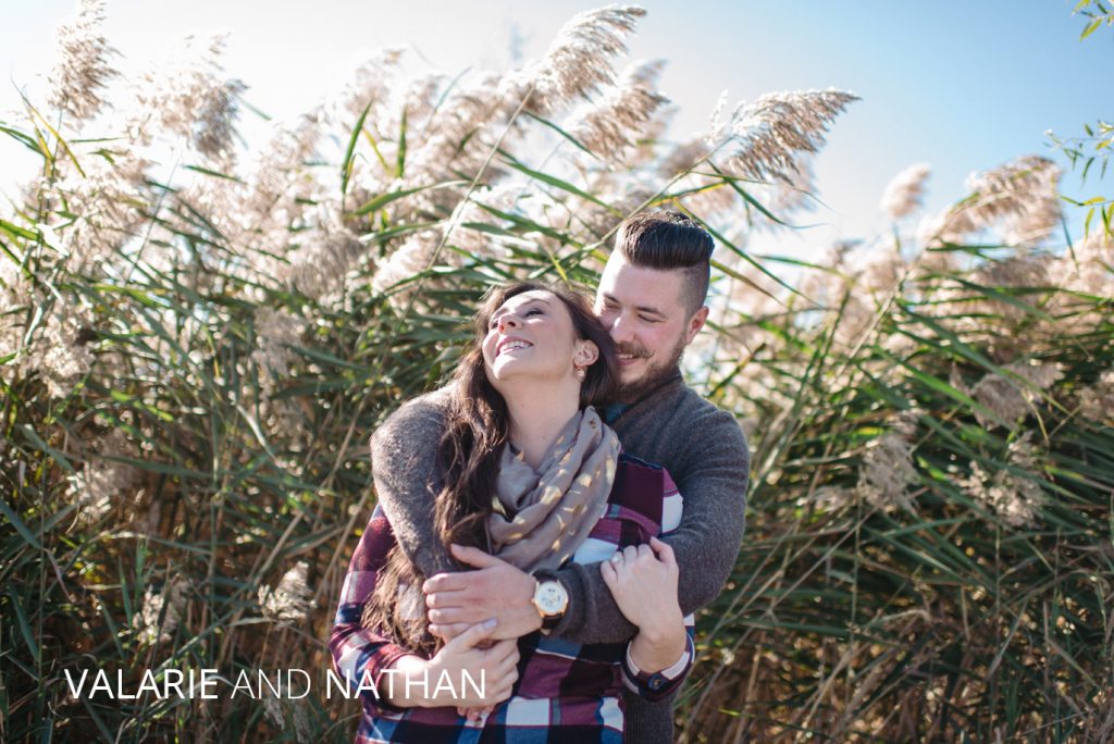 Engagement in Downtown Columbus | Jessica Miller Photography Valarie and Nathan hug in a field of tall grasses