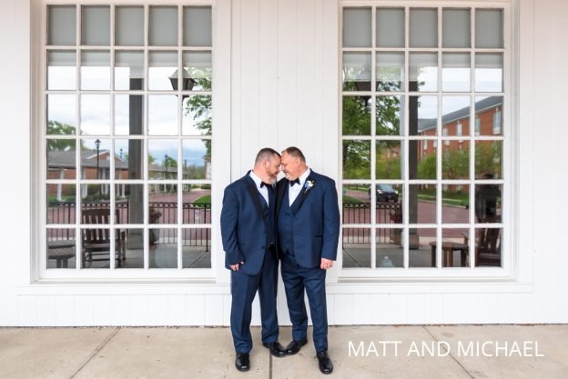 Two grooms touching foreheads