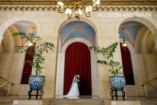 Bride and Groom kissing in a large doorway