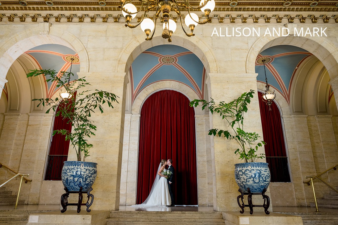 Bride and Groom kissing in a large doorway