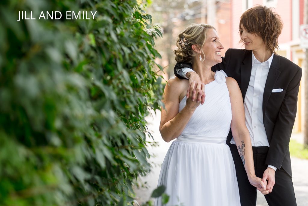 A newlywed lesbian couple shares a warm embrace on their wedding day
